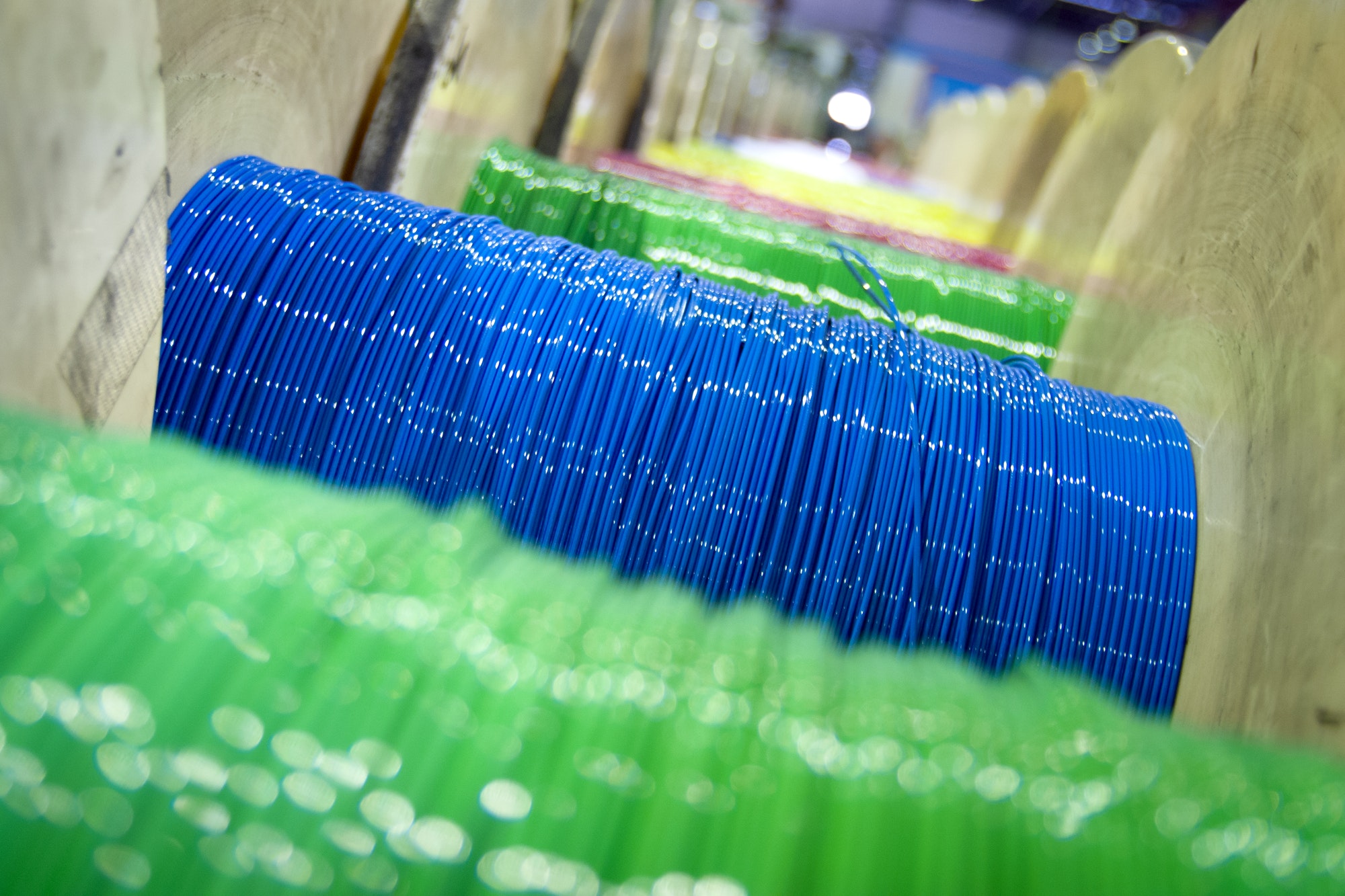 Group of fiber optic cable reels with intertwined optical fibers